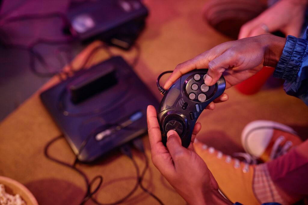 Top view closeup of black young man playing retro video game