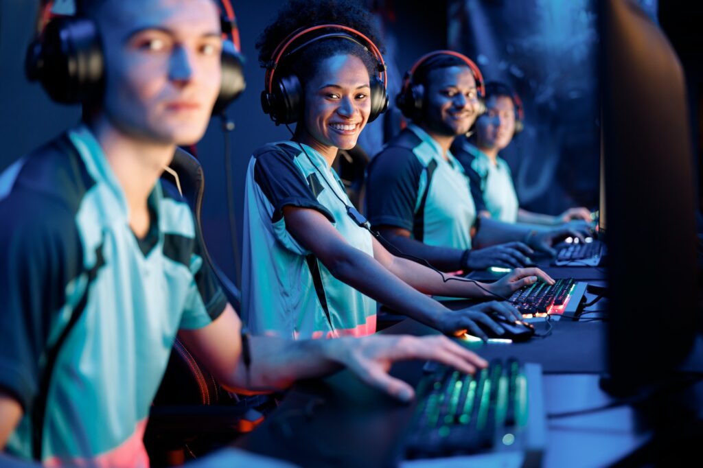 Young professional esports players playing games in internet cafe